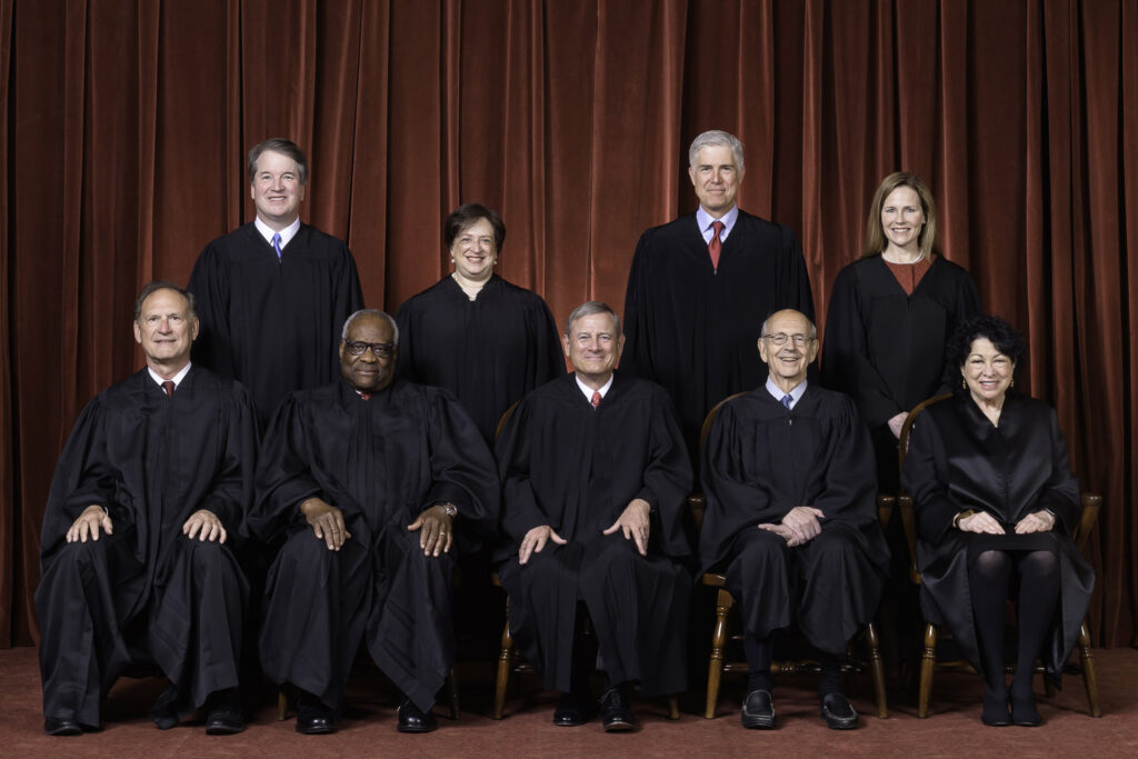 The Roberts Court, April 23, 2021   Seated from left to right: Justices Samuel A. Alito, Jr. and Clarence Thomas, Chief Justice John G. Roberts, Jr., and Justices Stephen G. Breyer and Sonia Sotomayor   Standing from left to right: Justices Brett M. Kavanaugh, Elena Kagan, Neil M. Gorsuch, and Amy Coney Barrett.   Photograph by Fred Schilling, Collection of the Supreme Court of the United States