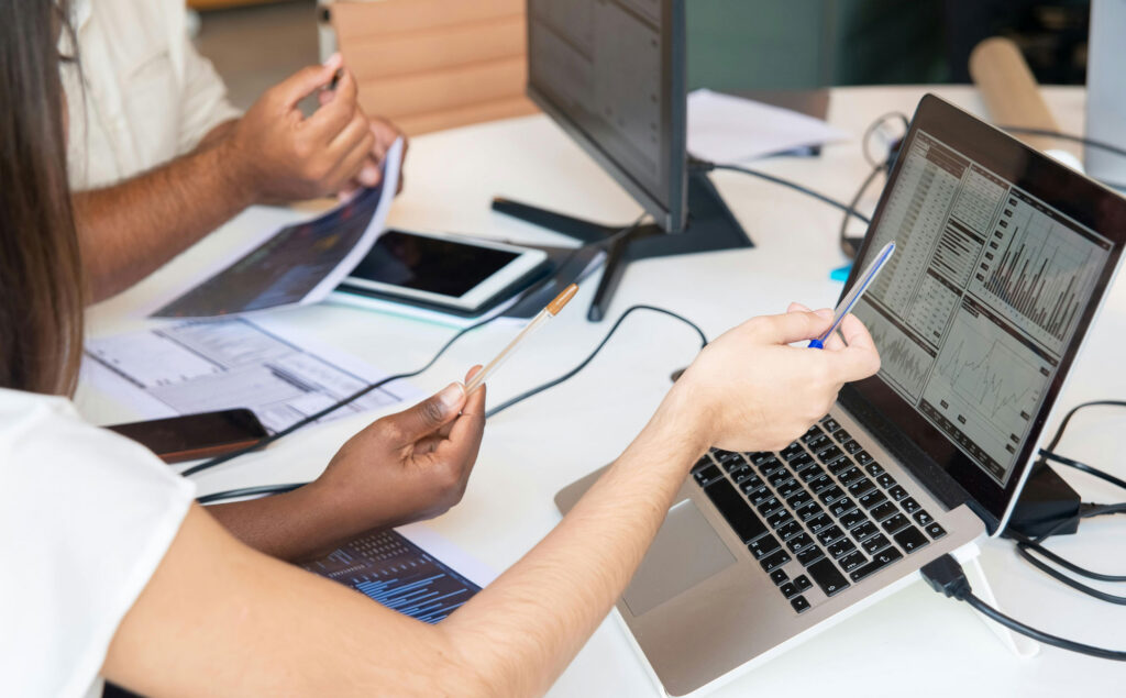 A team working around laptops and paperwork.