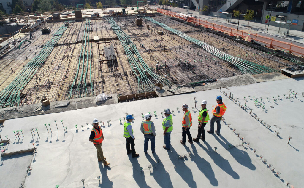 A group of inspectors and workers looking at a construction site