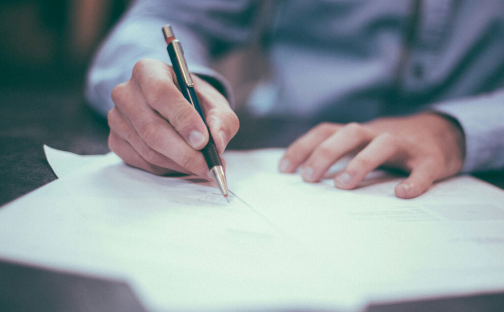 A man signing paperwork.